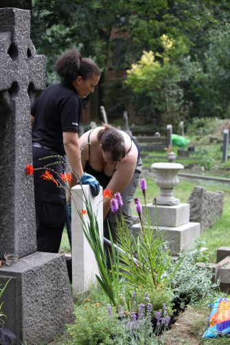 Community police assisting in graveyard clear-up